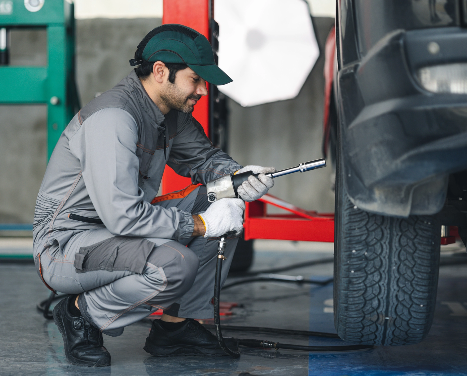 Mechanic checking air in car tire.