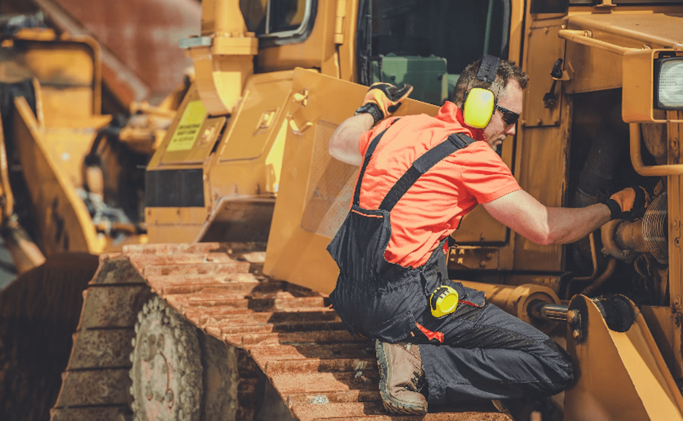Construction worker operating heavy machinery on site.