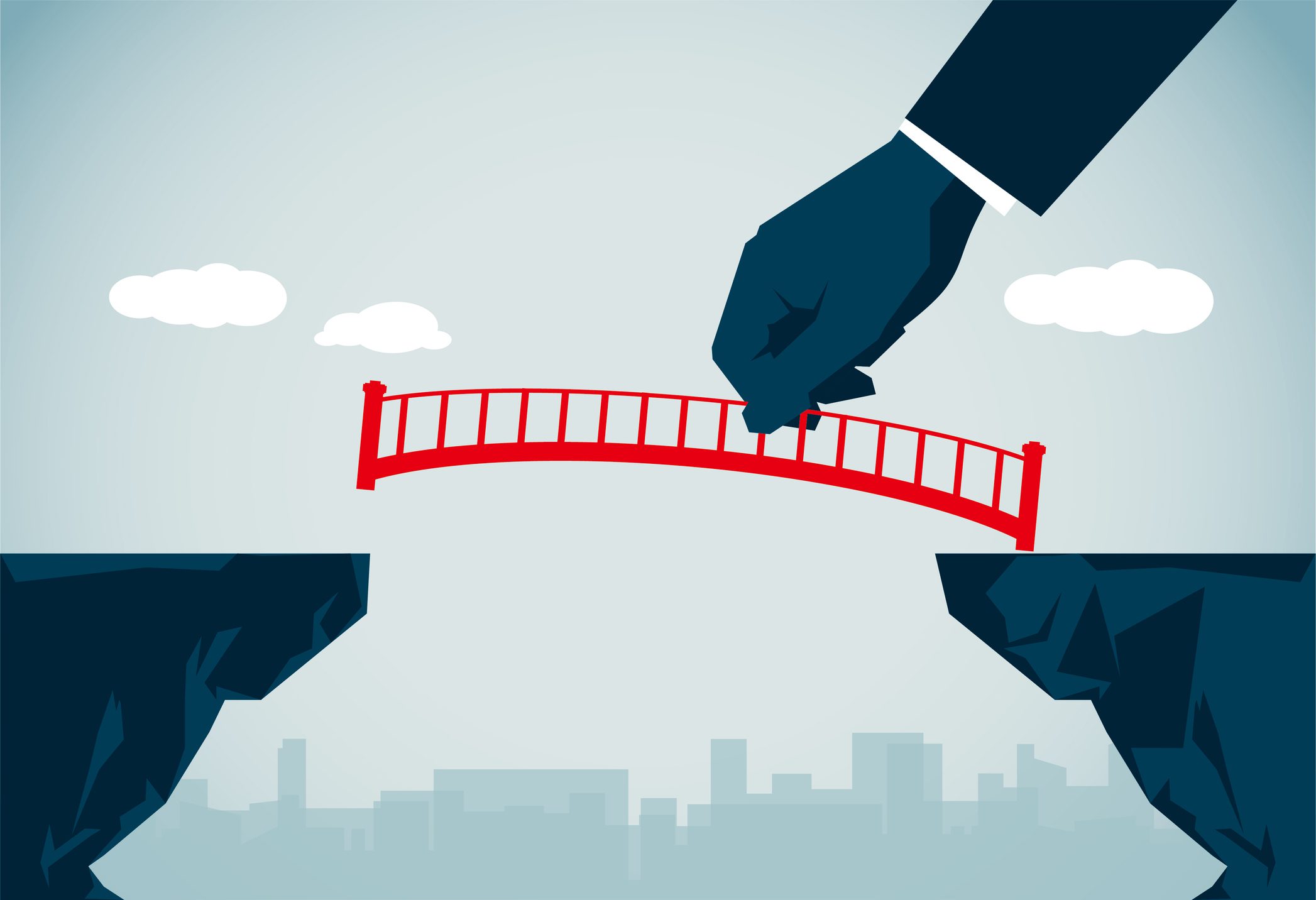Hand placing a red bridge between two cliffs symbolizing connection.